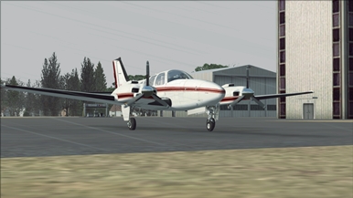 A business craft Beechcraft Baron 58 on a rainy day on a airfield in Britanny, France